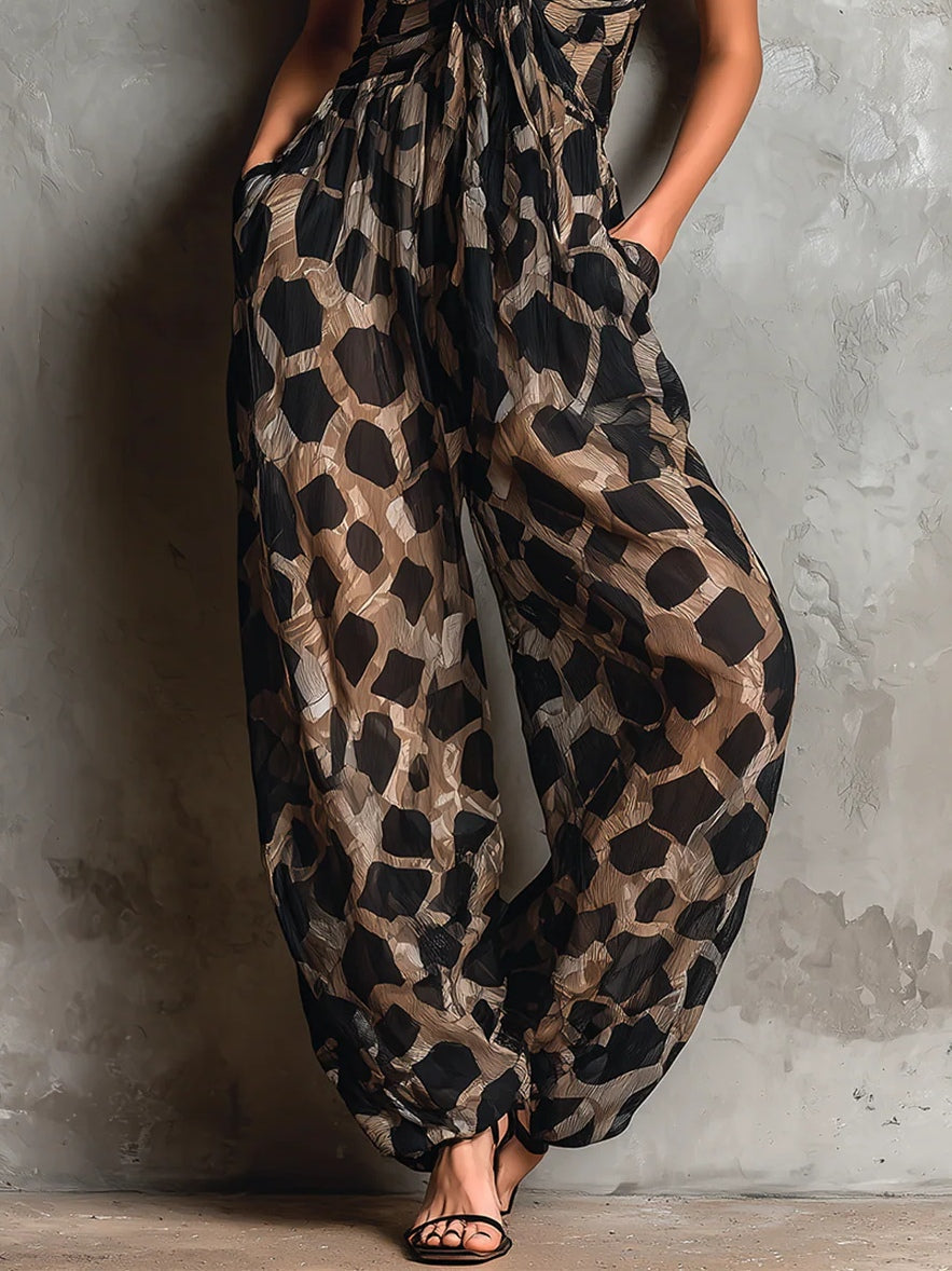 Roberta · Wide black chiffon jumpsuit with animal print, halter neck and pants